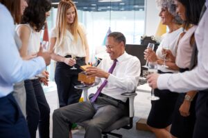 Coworkers celebrating a colleague’s retirement in the office