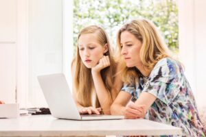 Mother and daughter using laptop