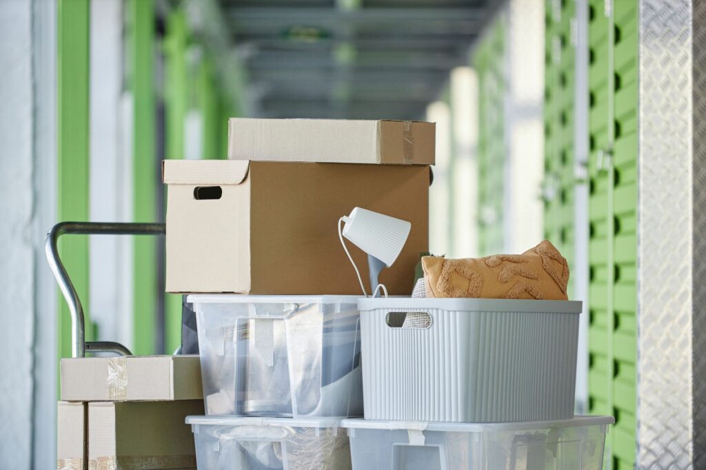 Cart Loaded with Stack of Boxes Storing Personal Possessions in Self Storage Warehouse