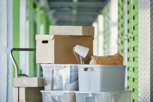 Cart Loaded with Stack of Boxes Storing Personal Possessions in Self Storage Warehouse