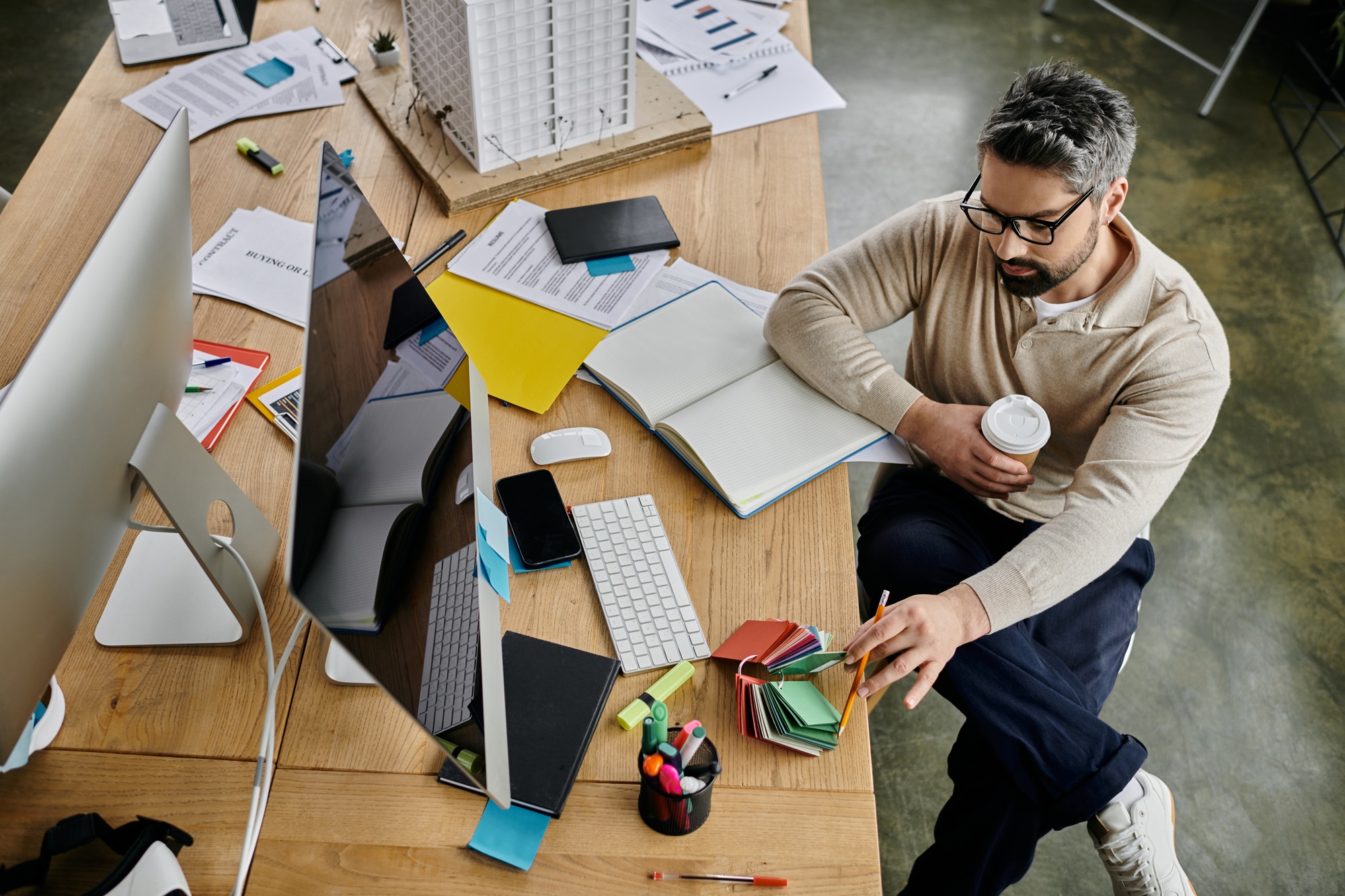 Chaos unleashed: a businessman amidst desk clutter